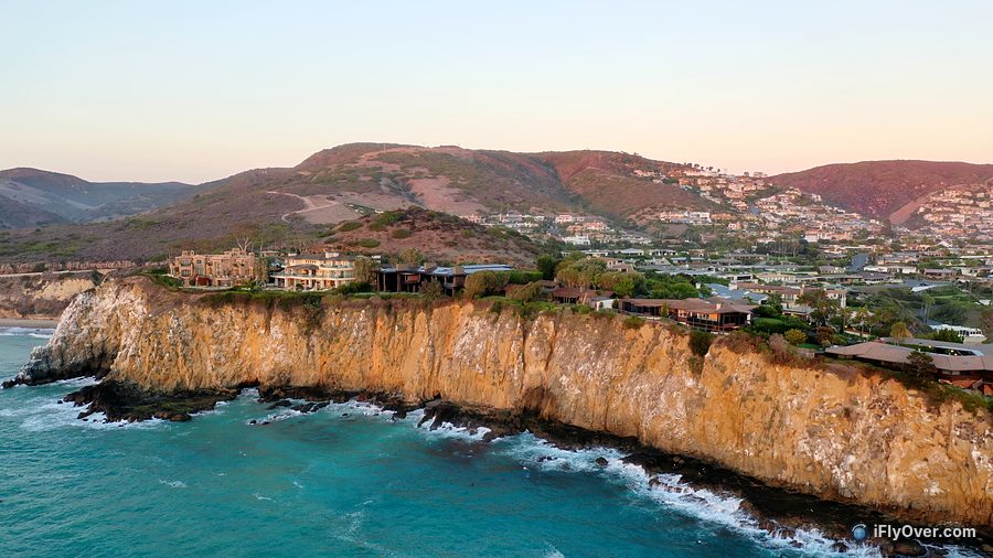 Aerial photo at sunset of homes on a headland above the ocean